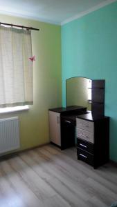 an empty room with a desk and a mirror at Apartment on Kravchuka 11b in Lutsk