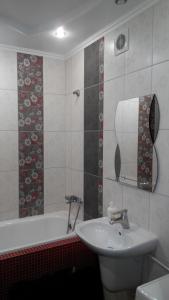 a bathroom with a sink and a bath tub at Apartment on Kravchuka 11b in Lutsk