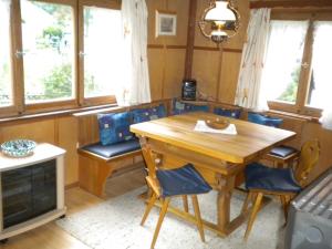 a dining room with a wooden table and chairs at Ferienhaus Sinz in Schwarzenberg