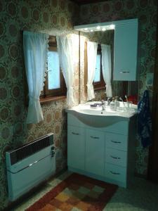 a bathroom with a sink and a mirror at Ferienhaus Sinz in Schwarzenberg im Bregenzerwald