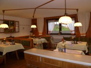 een eetkamer met 2 tafels met witte tafellakens bij Haus Lissi in Bad Füssing