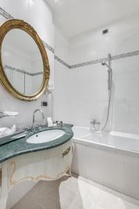 a bathroom with a sink and a mirror and a tub at Hotel Ca' dei Conti in Venice
