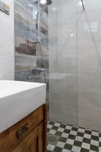 a bathroom with a white sink and a shower at Aia Vacation Apartment in Pärnu