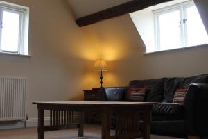 a living room with a couch and a table at Old Court Hotel & Apartments in Symonds Yat