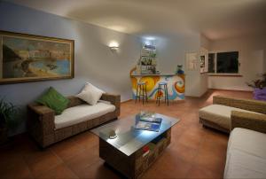 a living room with two couches and a coffee table at Iris Hotel in Ischia