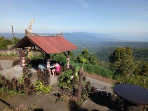 a group of people sitting in a gazebo at Puri Sunset Homestay in Munduk