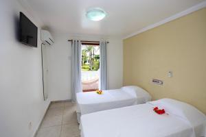 Postel nebo postele na pokoji v ubytování Benko´s Praia Hotel