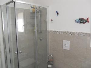 a shower with a glass door in a bathroom at Tenuta Sperlinga - Il Campanile in Santa Flavia