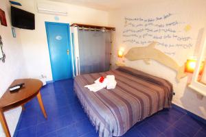 Cama ou camas em um quarto em L'Oasi Villaggio Albergo