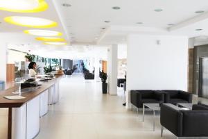 a lobby with a woman sitting at a counter at Alimounda Mare Hotel in Karpathos +37 photos