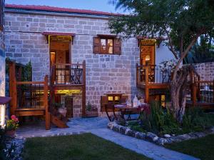 een huis met een patio en een tafel in de tuin bij Helios Garden Boutique Apartments in Rhodos-stad