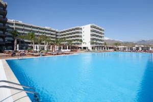 a large swimming pool in front of a building at Alimounda Mare Hotel in Karpathos