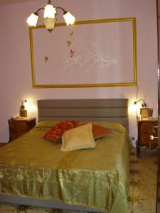 a bedroom with a bed with a large screen above it at Villa Aurea in Sciacca