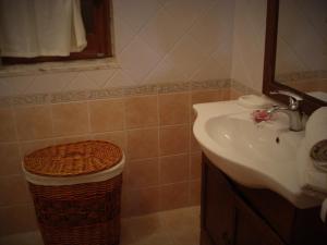 a bathroom with a sink and a trash can at Villa Aurea in Sciacca +32 photos