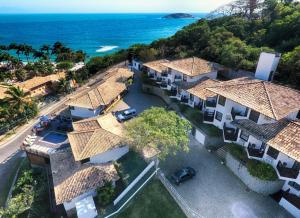 an aerial view of a house with the ocean at Coronado Inn Hotel in Búzios