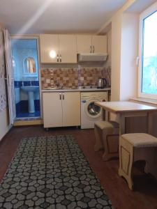 a kitchen with a washing machine and a table at Guest house near Baku airport in Baku