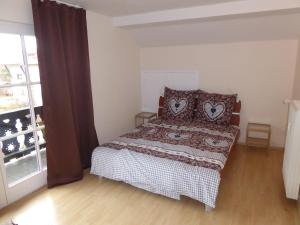 a bedroom with a bed and a large window at Fritz-Muller-Partenkirchen in Garmisch-Partenkirchen