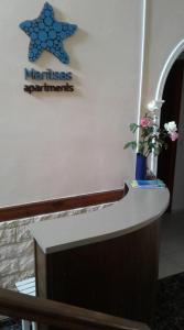 a counter with a star sign on a wall at Maritsas Apartments in Roda