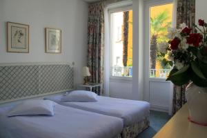 Un pat sau paturi într-o cameră la Piccolo Hotel