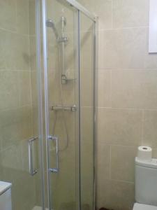 W łazience znajduje się prysznic ze szklanymi drzwiami. w obiekcie Castel Apartments w mieście Hospitalet de Llobregat