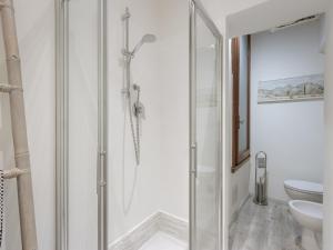 a bathroom with a shower and a toilet at Console House in Florence