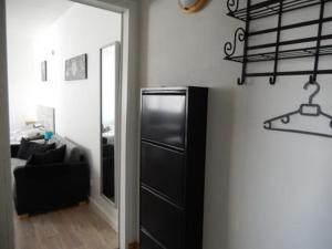 a black refrigerator in a room with a black chair at Le Studio Sam in Illkirch-Graffenstaden