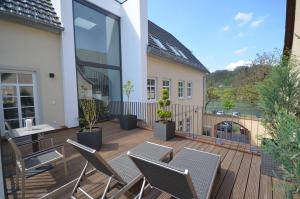 a patio with chairs and a table on a deck at Bella Riva Hotel in Marktheidenfeld