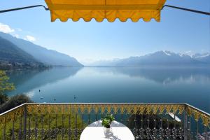 a view of a lake from a balcony at Golf Hotel René Capt in Montreux