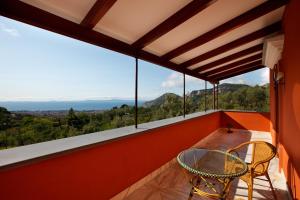 a balcony with a glass table and chairs on it at Antico Casale Russo in Piano di Sorrento +31 photos