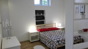 a small bedroom with a bed and a window at City Apartment Goga in Pula