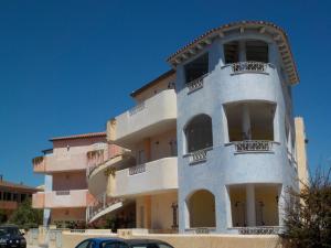 a building with balconies on the side of it at Appartamento l'Aurora in Santa Teresa Gallura