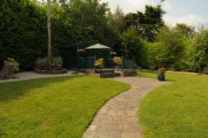 a garden with a bench and a gazebo at Killererin House B&B in Letterkenny