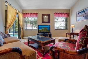 a living room with a couch and a tv at Villa Maxine in Cape Coral