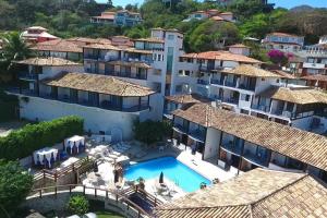an aerial view of a building with a swimming pool at Coronado Beach Hotel in Búzios