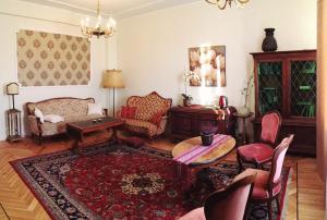 a living room with a couch and a table and chairs at Posti Apartment in Haapsalu