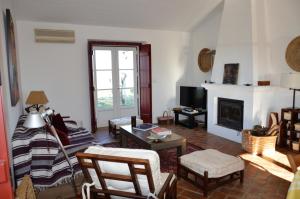 a living room with a couch and a fireplace at Monte da Boavista - Country family house in Alter do Chão