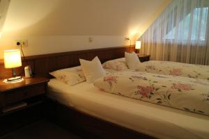 a bedroom with a bed and two lamps and a window at Haus Schneider in Gutach