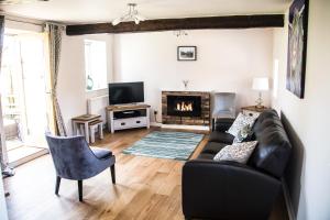 a living room with a couch and a fireplace at The Old Granary in York