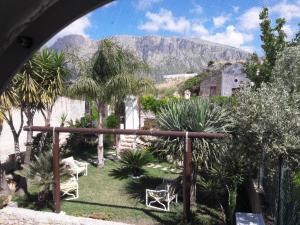 a view of a garden with a mountain in the background at Rustico San Leonardo in Cinisi