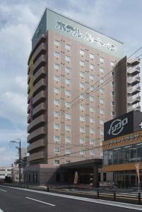 um grande edifício com escrita ao lado em Hotel Route-Inn Toki em Toki