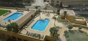 an overhead view of two swimming pools in a building at Jbr Beach Walk Rimal 3 in Dubai