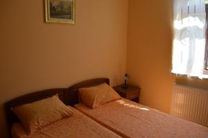 a bedroom with two beds and a window at Apartments Villa Sandra in Opatija