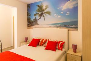a bedroom with a bed with a picture of a beach at Apartments & Studios Tomanović in Budva