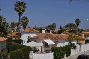 a view of a house with palm trees at Family Beach Villa Rubens in Oliva