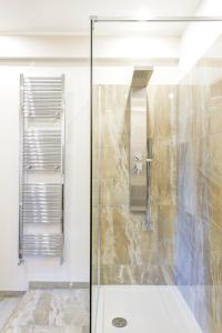 a shower with a glass door in a bathroom at RHS Rienzo Suites in Rome