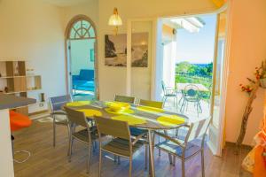 a kitchen and dining room with a table and chairs at Casa Marco - Villa alle Cascine - Imperia in Imperia