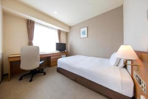 a hotel room with a bed and a desk and a computer at Rembrandt Hotel Tokyo-Machida in Machida +40 photos
