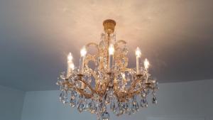a chandelier is hanging from a ceiling at Apartment nahe Rosenhügel in Vienna