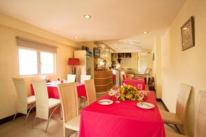 a dining room with red tables and white chairs at Lien An Sai Gon Hotel in Ho Chi Minh City +31 photos