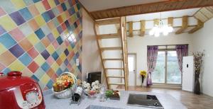 a kitchen with a room with a colorful wall at Gyeongju Family Pension in Gyeongju